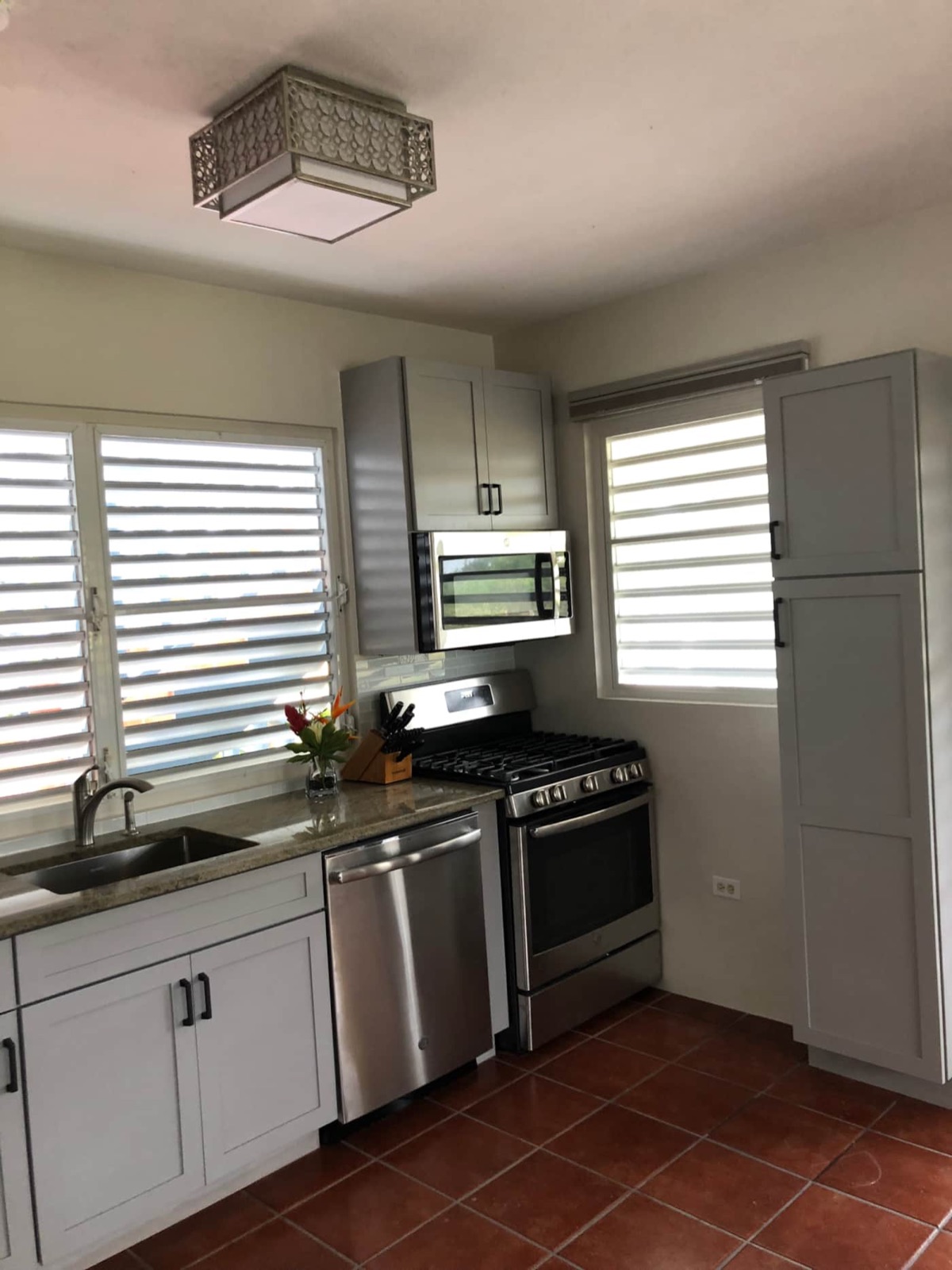 Kitchen with six-burner gas range, microwave and dishwasher